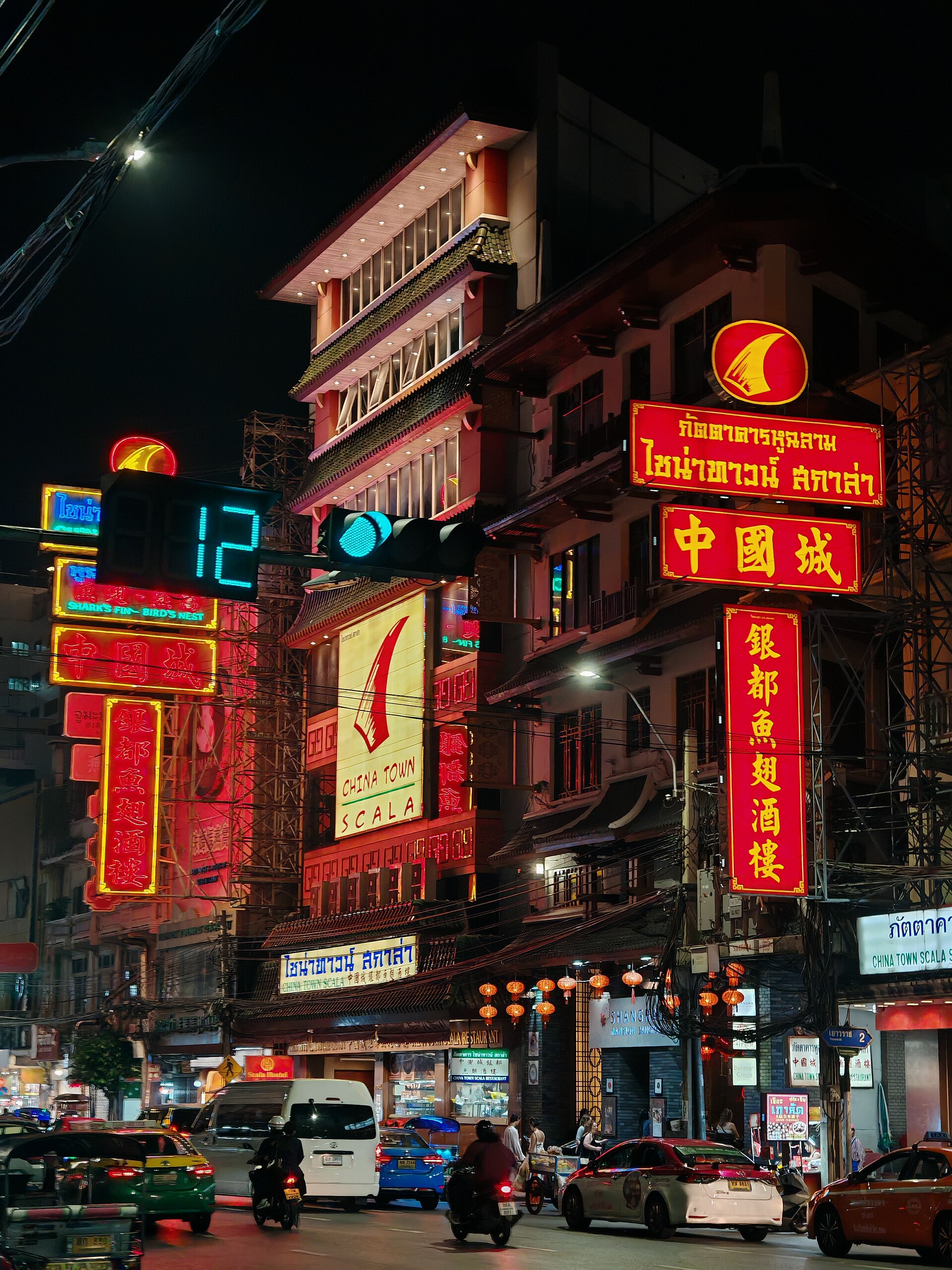 Neon signs, traffic, and street life on Yaowarat Road at night